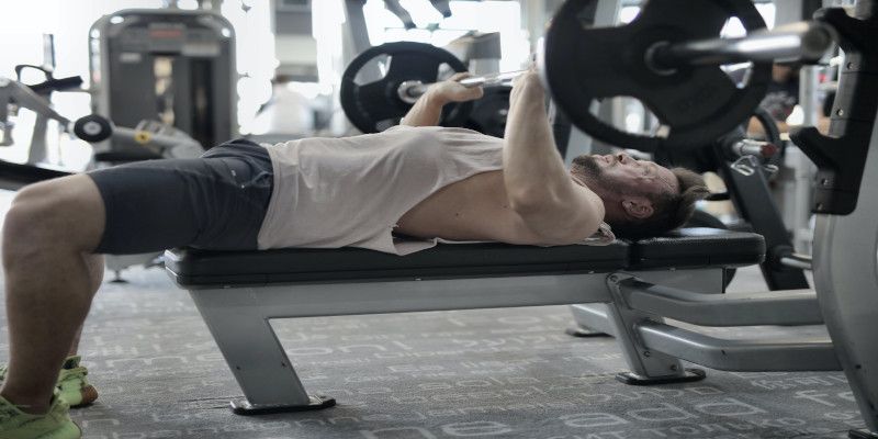 A man bench pressing in the gym.