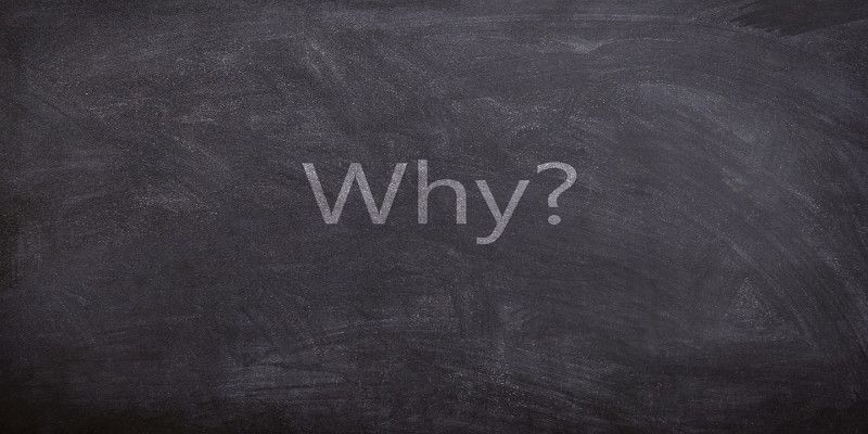 The word “why?” written with white chalk on a blackboard.