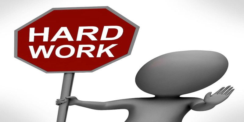Image of a stop sign reading “hard work.”