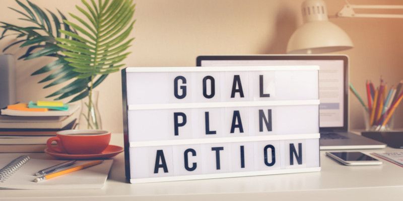 Goal, plan, action text on light box on desk table in home office. Business motivation or inspiration, performance of human concepts ideas.