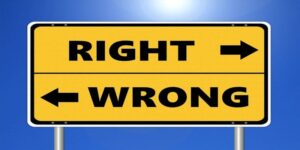 Sign saying right to the right and wrong to the left with a blue background.