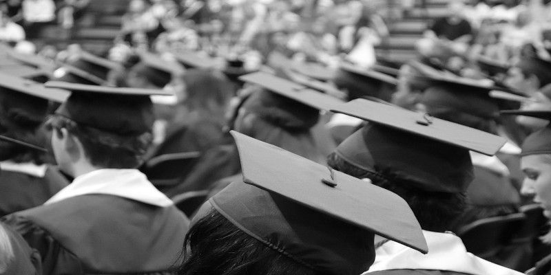 Black and white picture of multiple students graduating.