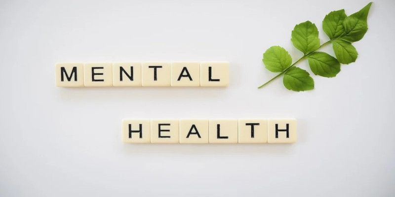 Picture showing the words mental health and a green leaf on a white background.