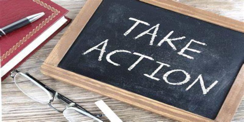 “Take action” written with white chalk on a blackboard.
