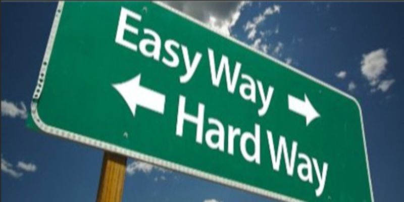 Image of a traffic sign saying easy way to the right, hard way to the left.