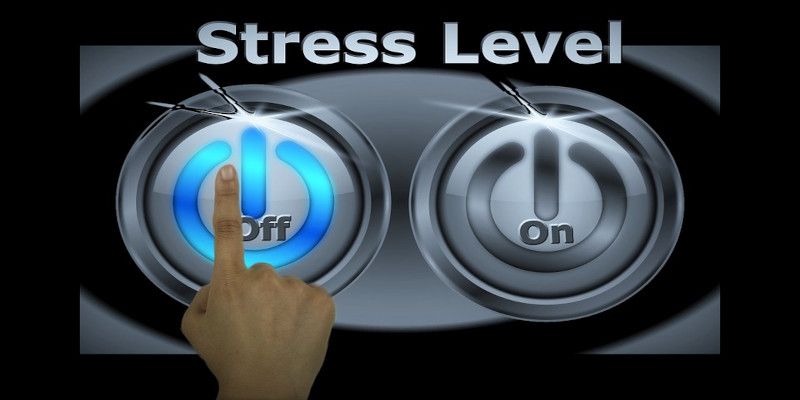 A hand pushing the “off” button with the sentence “stress level” written above it.
