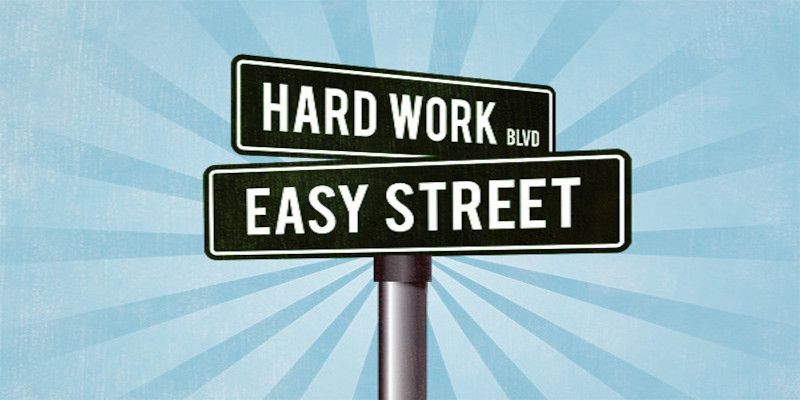 Illustration of two road signs reading, “hard work”, and “easy street”.