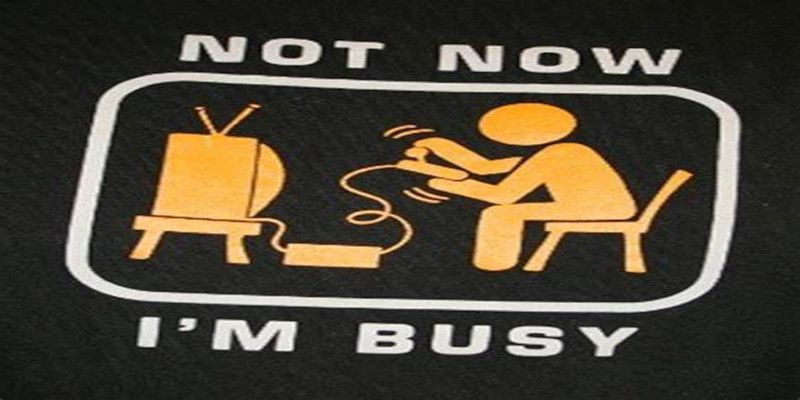 Illustration of someone playing video games with the funny quote, “not now, I'm busy.”