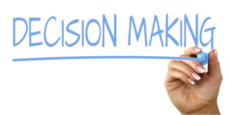 Image of the words “decision-making” written with a blue marker.