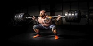 Image of a man performing a back squat with a barbell.