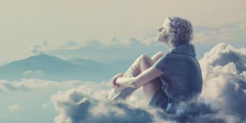 Image of a person sitting on a cloud looking at the world from high up in the sky, signifying a dream.