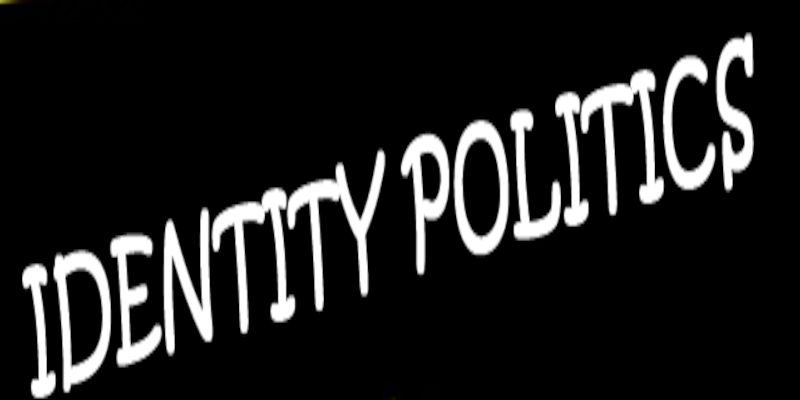 The words “identity politics” written in white letters on a black background.