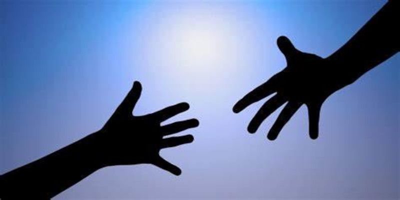 Image of two hands reaching toward each other indicating trust between one another.