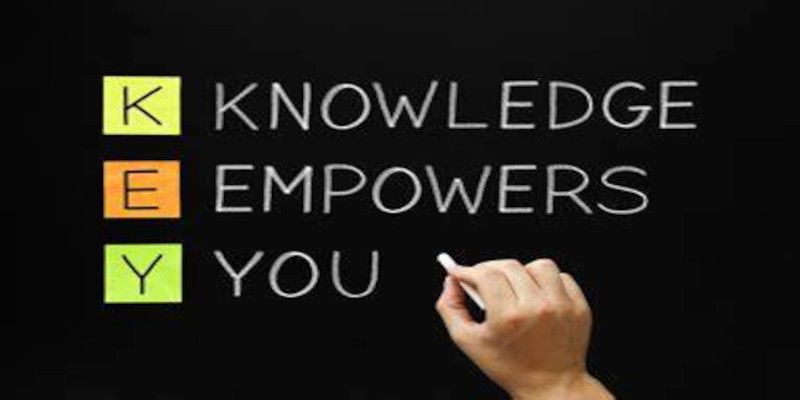 The words “knowledge empowers you” written on a blackboard with chalk by someone's hand.