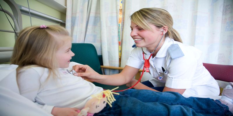 Image of a female nurse caring for a child in the hospital.