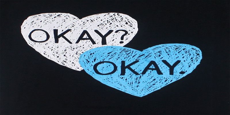 Illustration of a white heart with the word “okay?” written inside, and a blue heart saying “okay.” underneath it.
