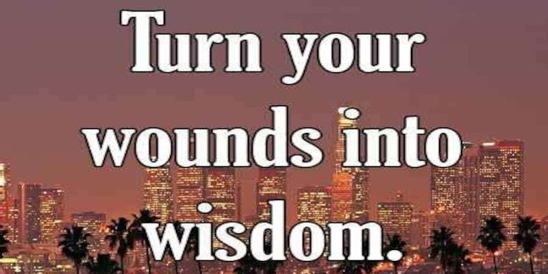 The quote, “turn your wounds into wisdom” written on a background.