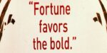 The quote, “fortune favors the bold” written in red letters on a white background.