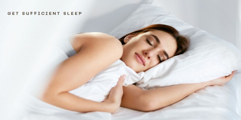 Image of a woman sleeping in white bed covers