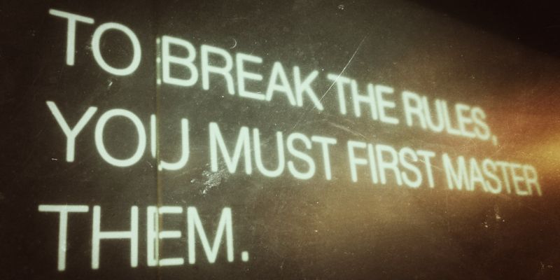A sign saying, “to break the rules, you must first master them”.