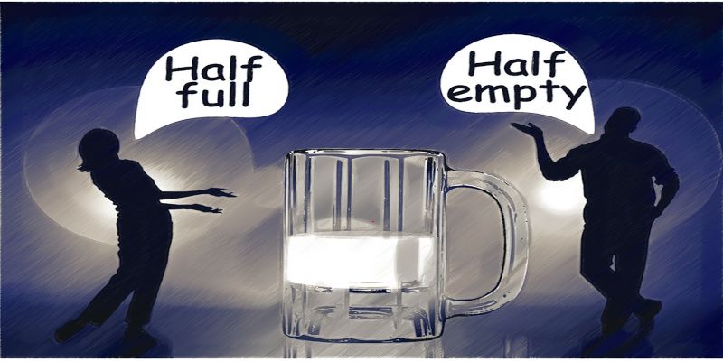 Illustration of a glass that's half full and half empty with two individuals viewing it differently.