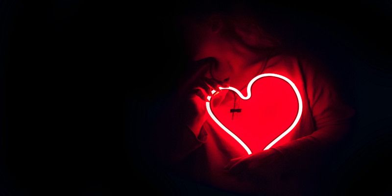 Man holding a heart that glows.