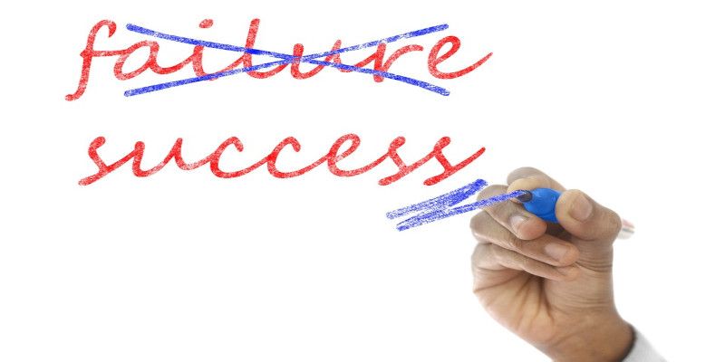 The word “failure” is crossed out by a blue marker, while the word “success” is being highlighted with a blue marker.