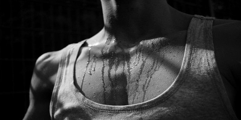 Black and white image of a person sweating.